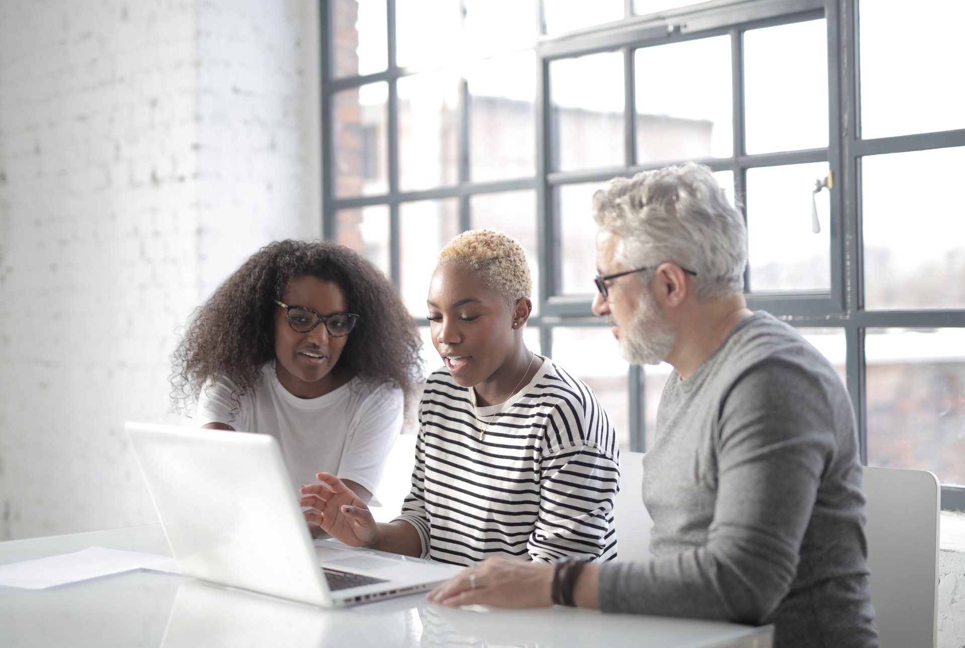 concentrated multiracial coworkers working on laptop in 3866369